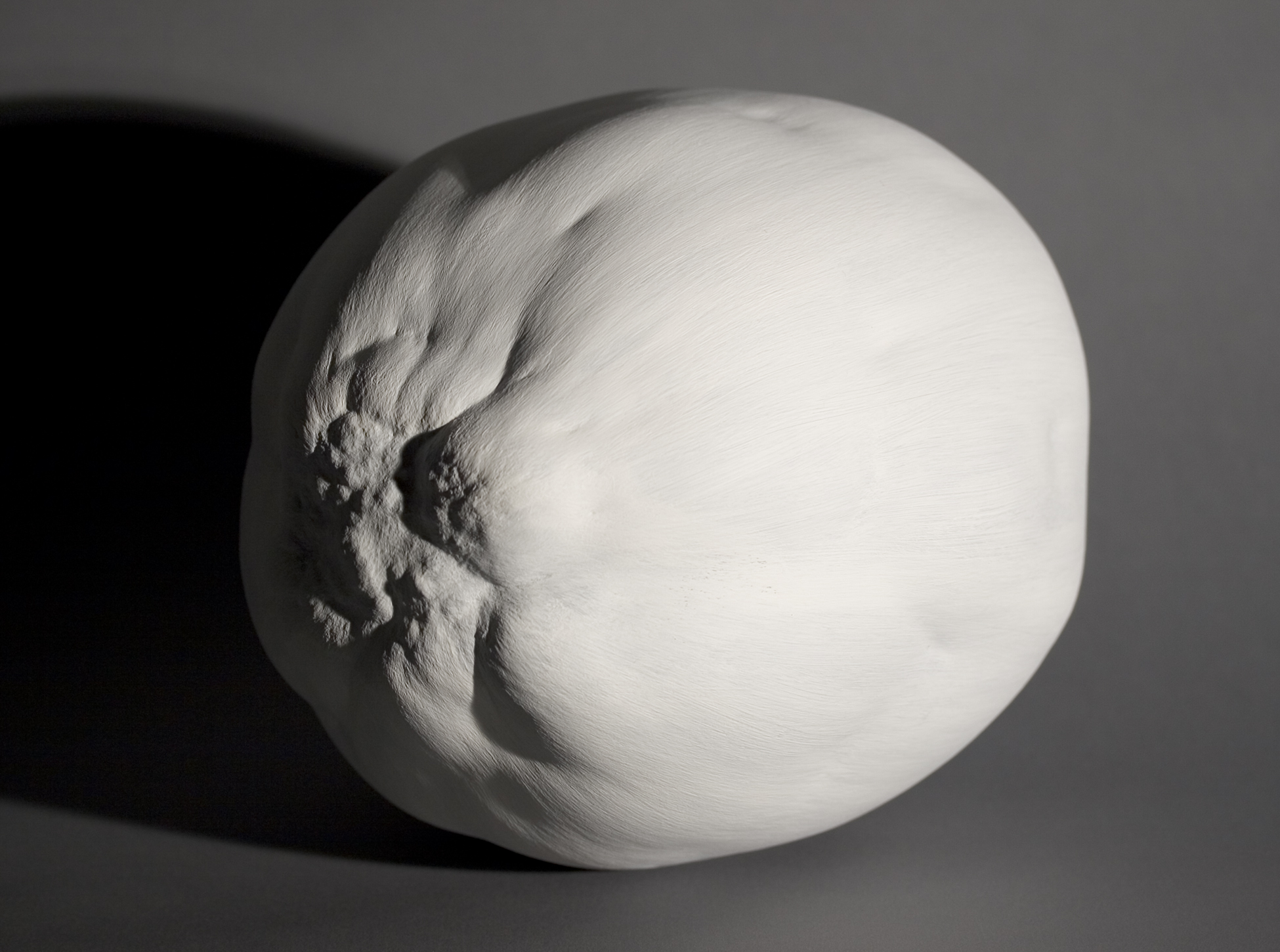 A photograph of Eric Cameron’s “Thick Painting: Edwin’s Egg” depicting a white sculpture made of acrylic gesso shaped like an egg. 