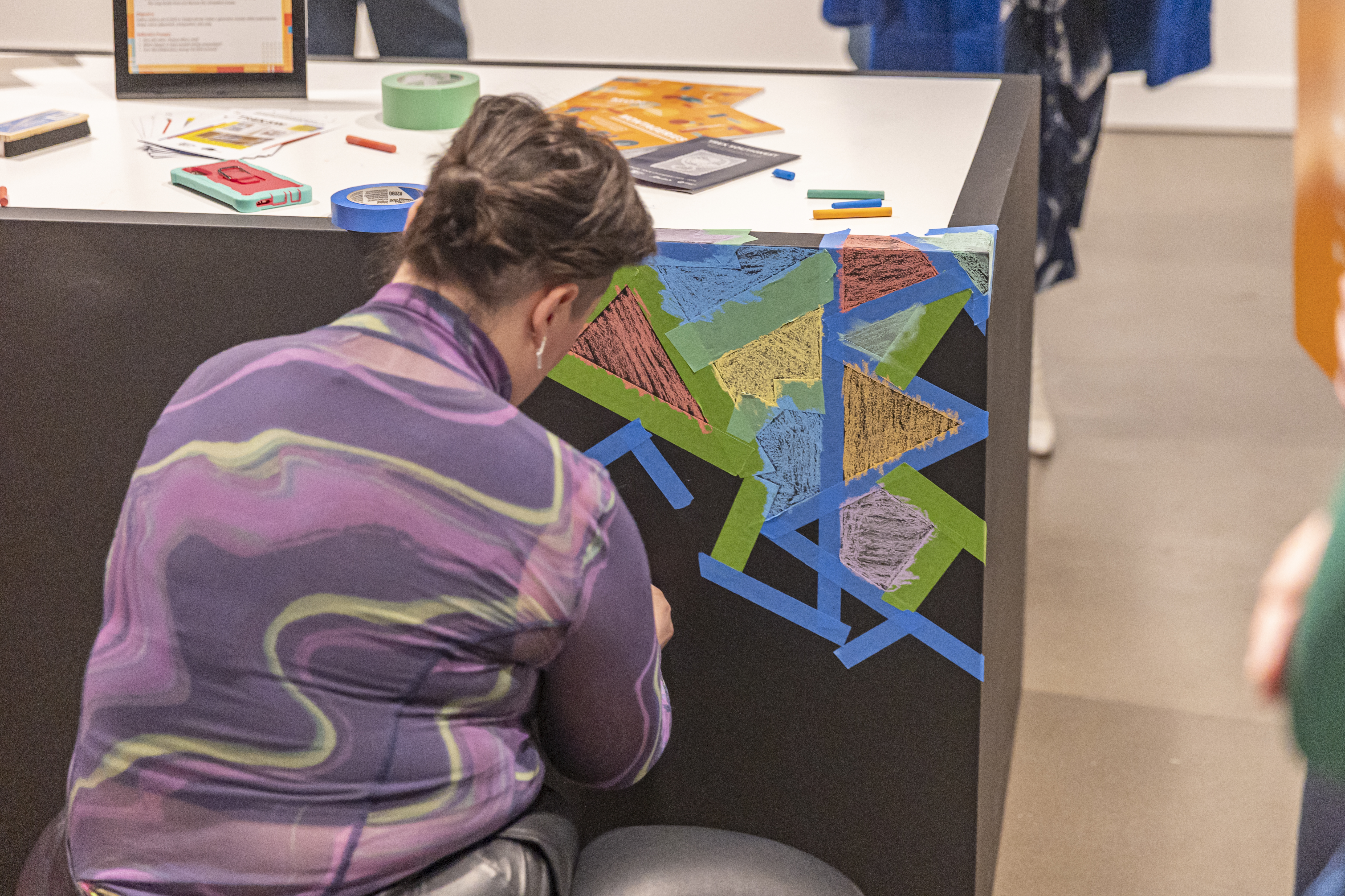 An attendee creates art of her own at the AFA art house.