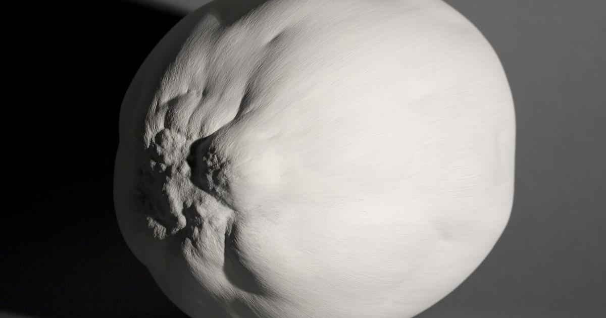 A photograph of Eric Cameron’s “Thick Painting: Edwin’s Egg” depicting a white sculpture made of acrylic gesso shaped like an egg. 