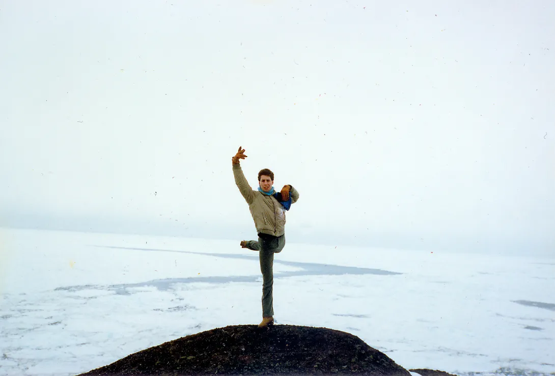 Paul Reich performing an arabesque with the Atlantic Ocean in the background,